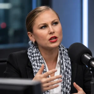 Grace Tame speaking in a broadcast studio