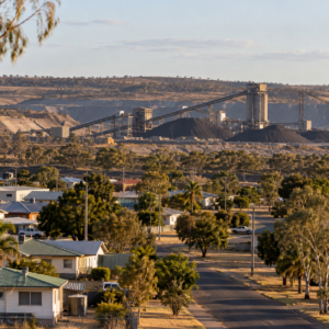 Glenden-style mining town homes with a large mine and coal infrastructure beyond.