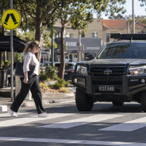 AI-generated illustrative image representing pedestrian risk around larger vehicles.