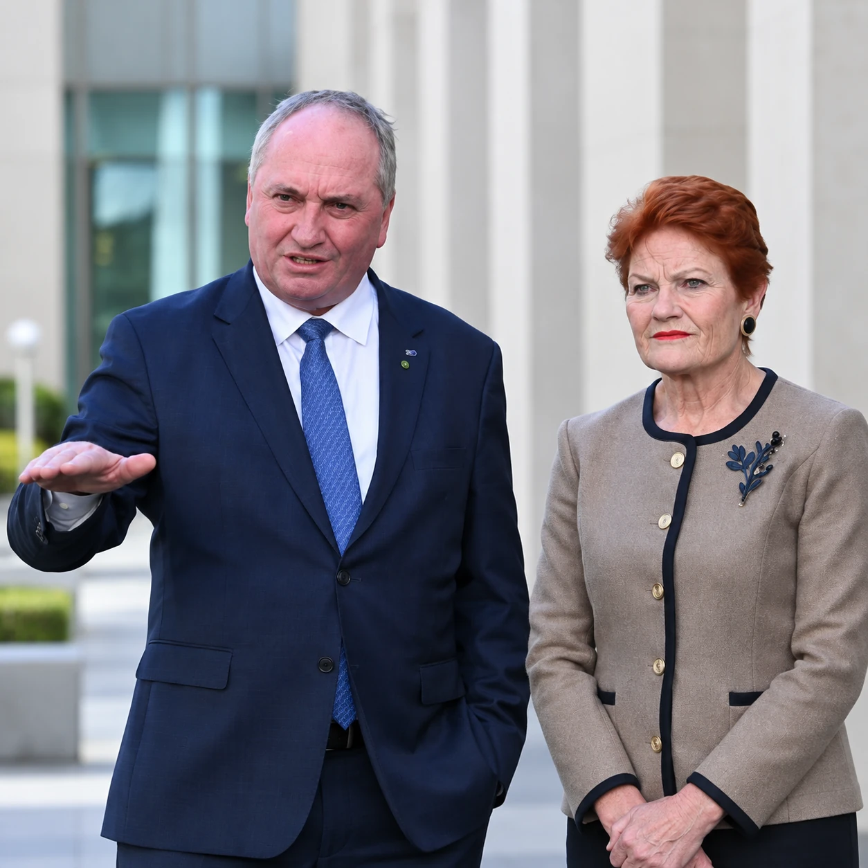 Two people standing outside a public building