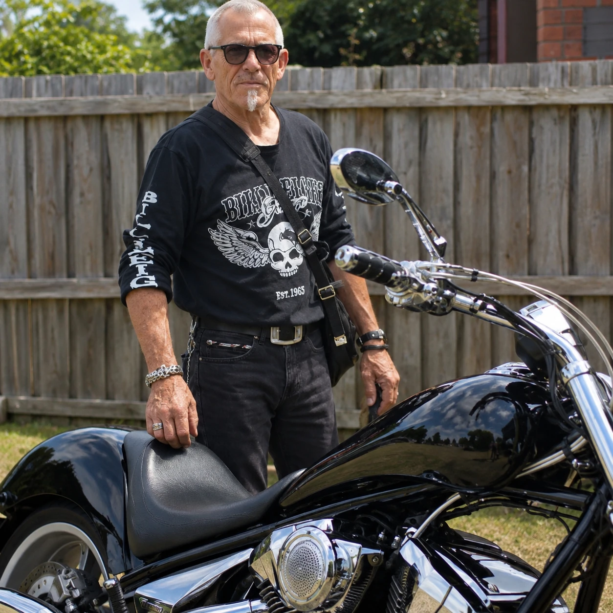 Peter Tiki Mason standing beside a black motorcycle